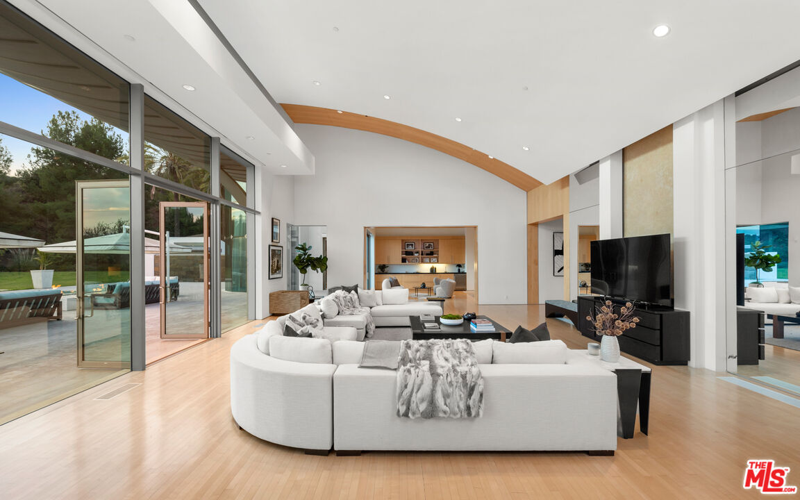 72 Beverly Park Beverly Hills, CA 90210 - Photo 13 of 38 a living room with fireplace furniture and a flat screen tv