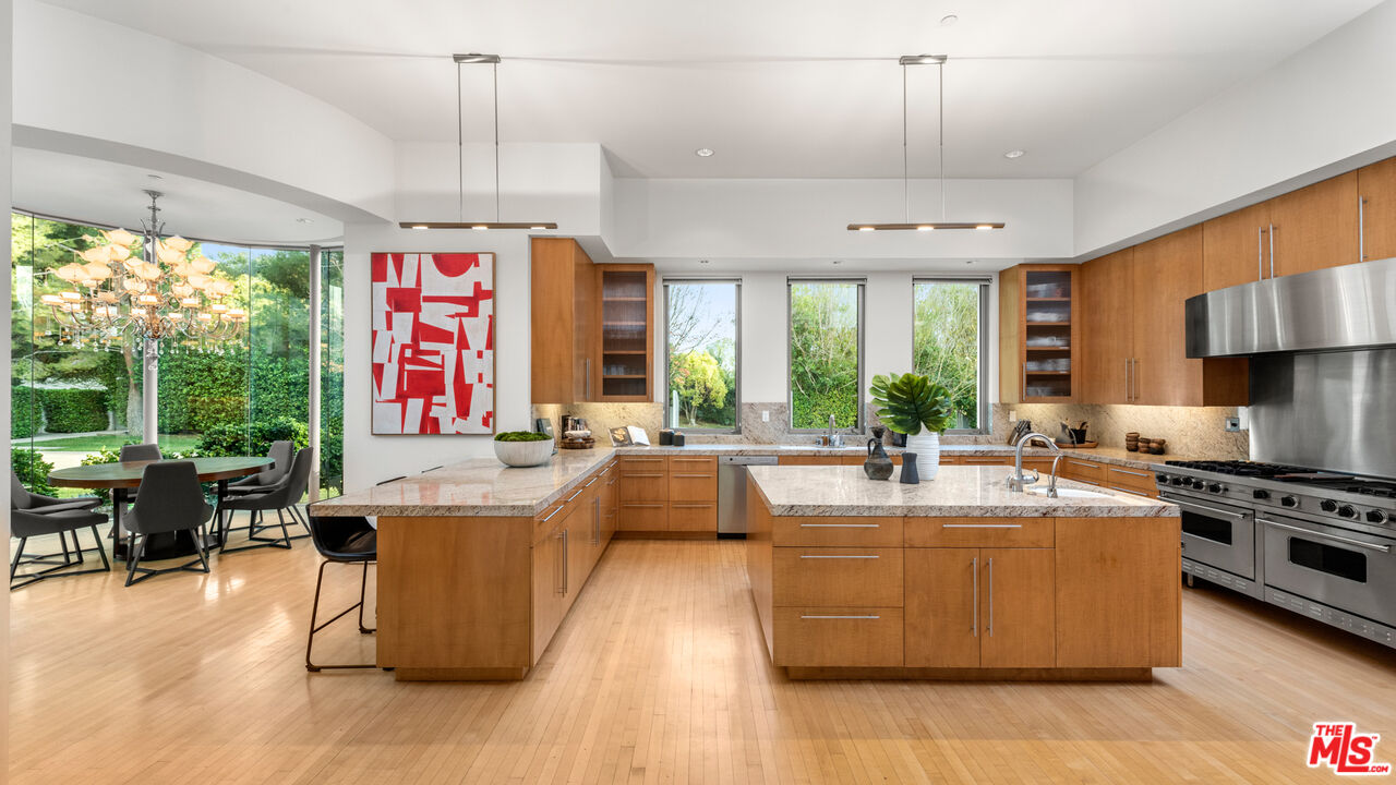 72 Beverly Park Beverly Hills, CA 90210 - Photo 18 of 38 a large kitchen with kitchen island a large counter space a large window cabinets and stainless steel appliances