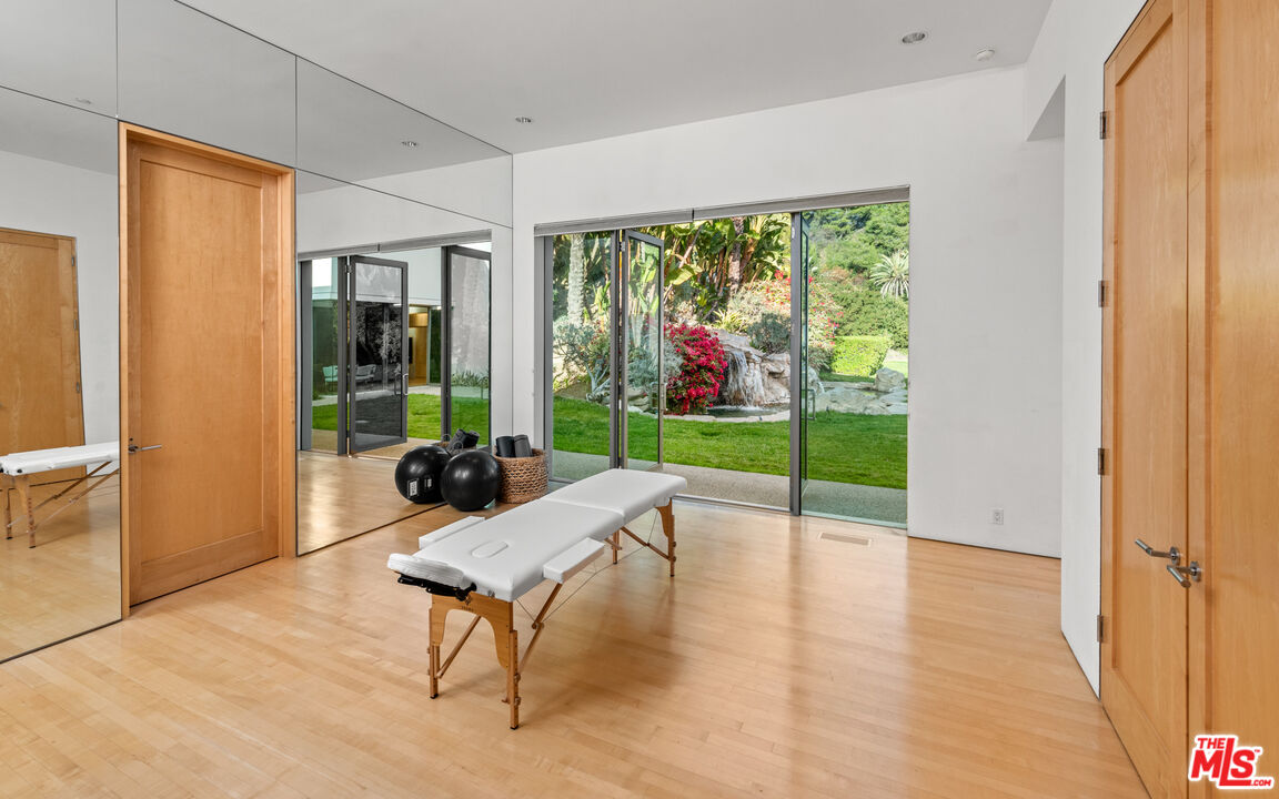 72 Beverly Park Beverly Hills, CA 90210 - Photo 28 of 38 a living room with furniture and a floor to ceiling window