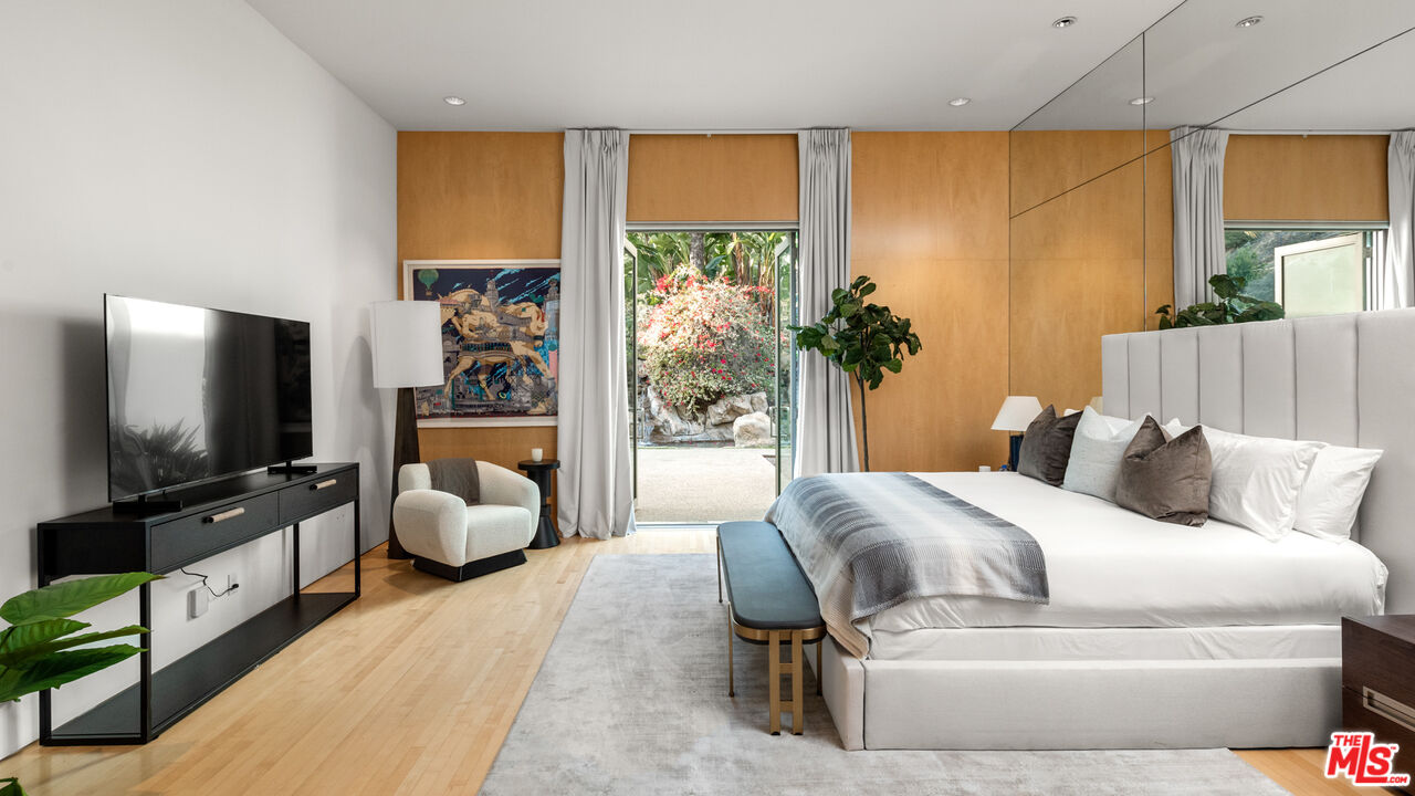 72 Beverly Park Beverly Hills, CA 90210 - Photo 29 of 38 a bed room with a bed television and a large window