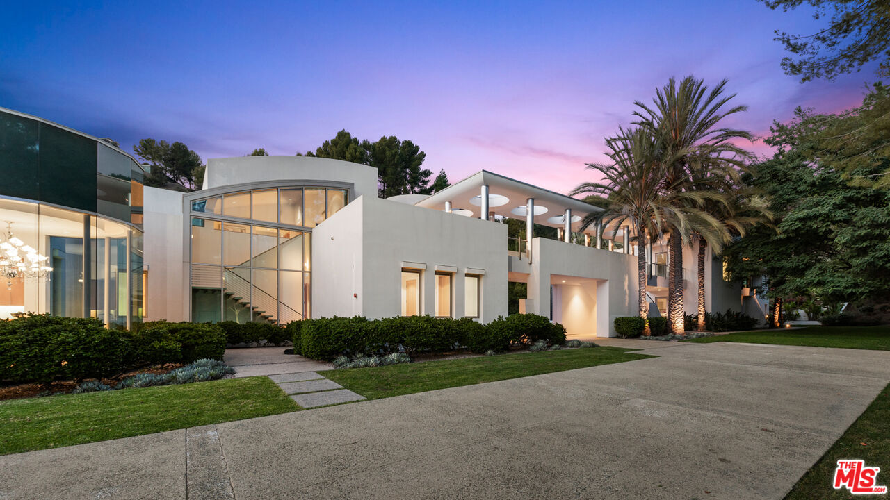 72 Beverly Park Beverly Hills, CA 90210 - Photo 3 of 38 a front view of a house with a yard and garage