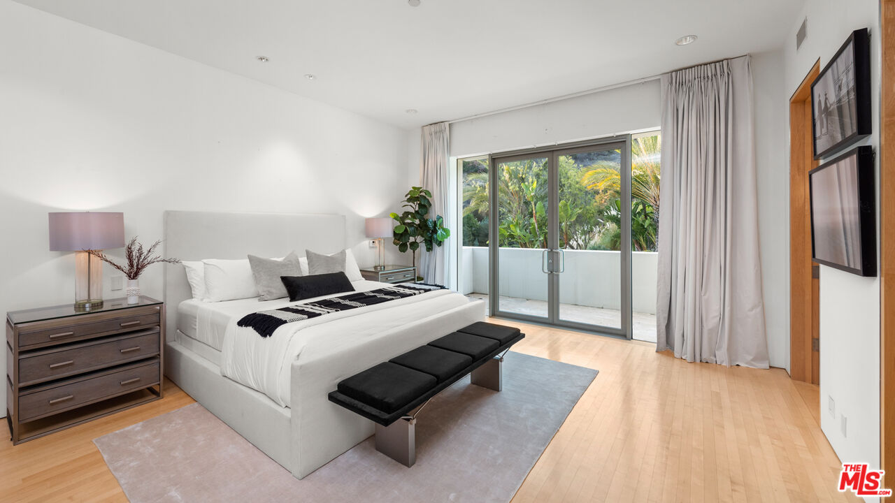 72 Beverly Park Beverly Hills, CA 90210 - Photo 31 of 38 a bed room with a bed and a night stand