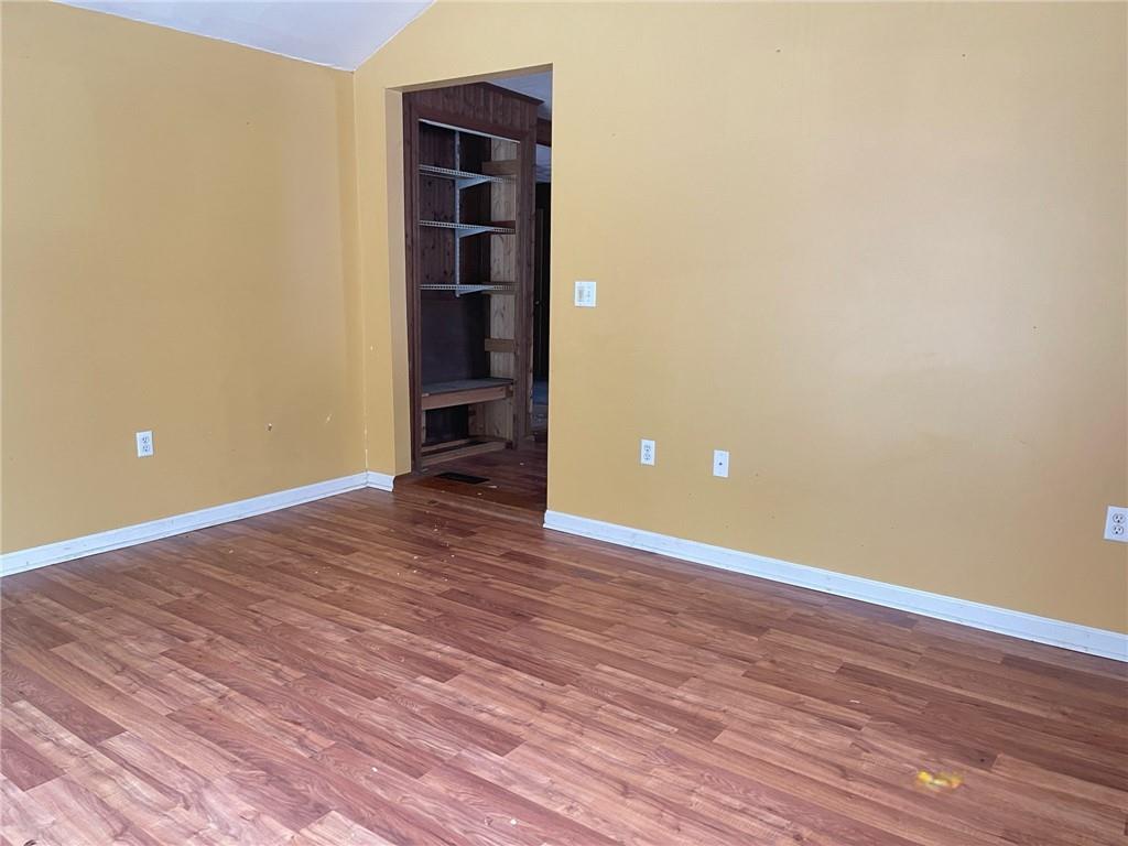 88 Fleming Road Grove City, PA 16127 - Photo 8 of 20 a view of an empty room with wooden floor and closet