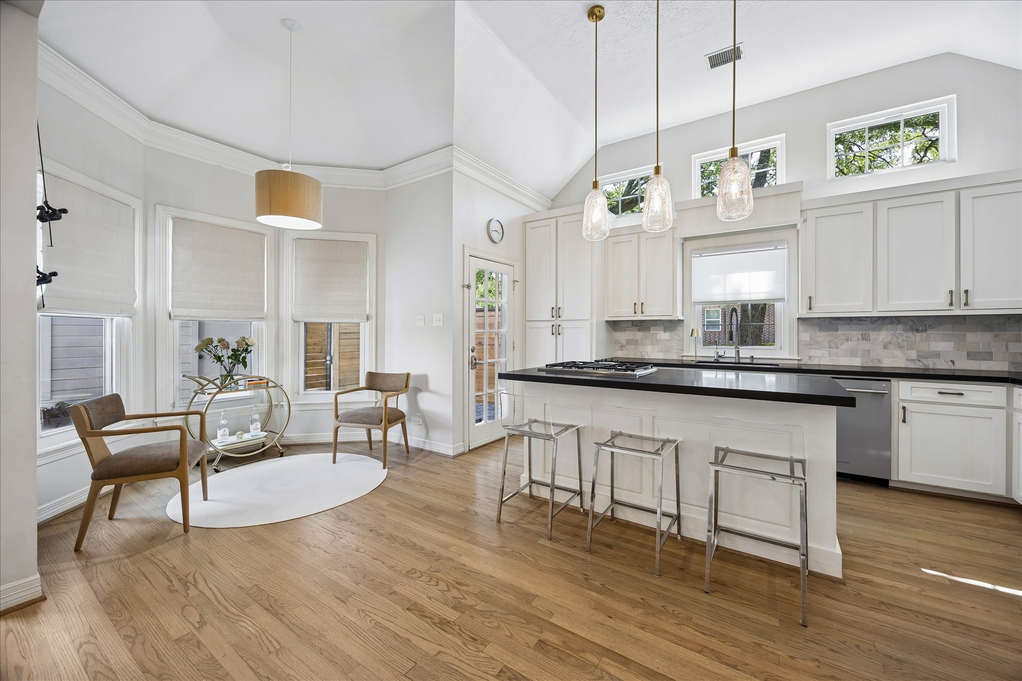 4131 Sunset Boulevard Houston, TX 77005 - Photo 10 of 38 a large living room with kitchen island granite countertop wooden floor stainless steel appliances and cabinets