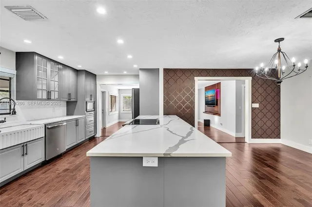 a kitchen with a sink stainless steel appliances and cabinets
