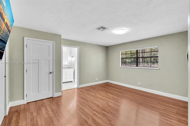 a bathroom with a granite countertop sink toilet a large mirror a shower and vanity
