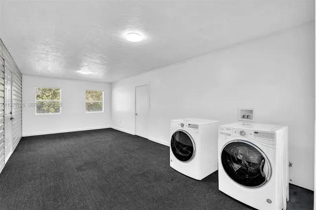 a view of an empty room with a fireplace and a large window