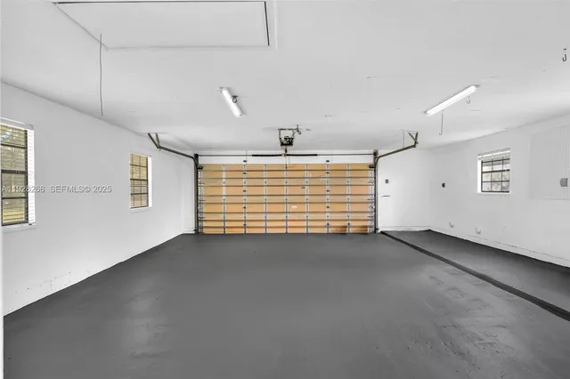 a view of empty room with wooden floor and balcony