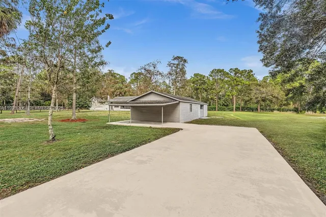 a view of a house with a backyard