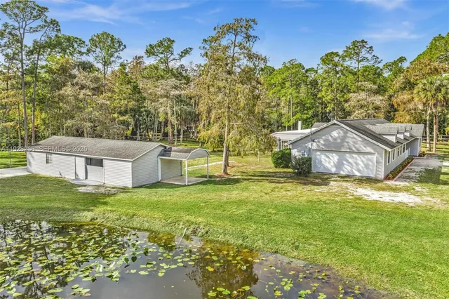 a view of kitchen with refrigerator stove and wooden floor