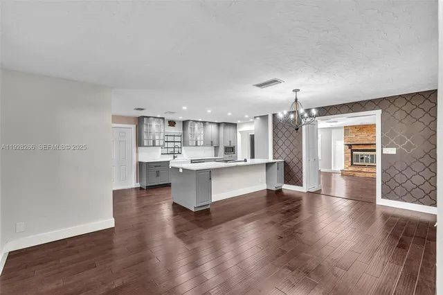a view of kitchen with center island and stainless steel appliances