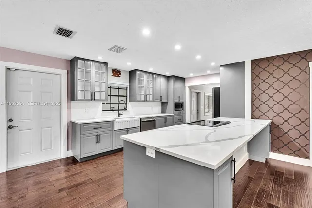 a view of kitchen with sink microwave and refrigerator