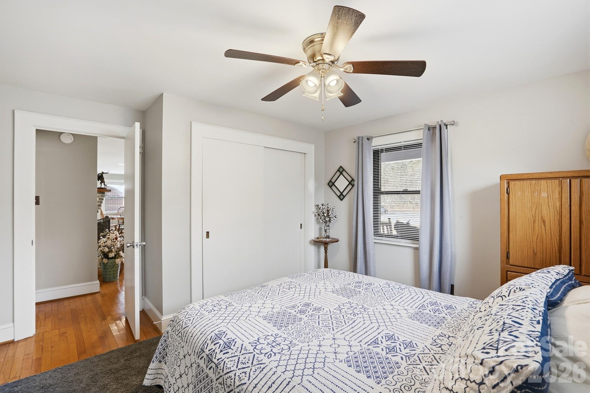 7511 Old Mocksville Road Salisbury, NC 28144 - Photo 24 of 48 a bedroom with a bed and a chandelier