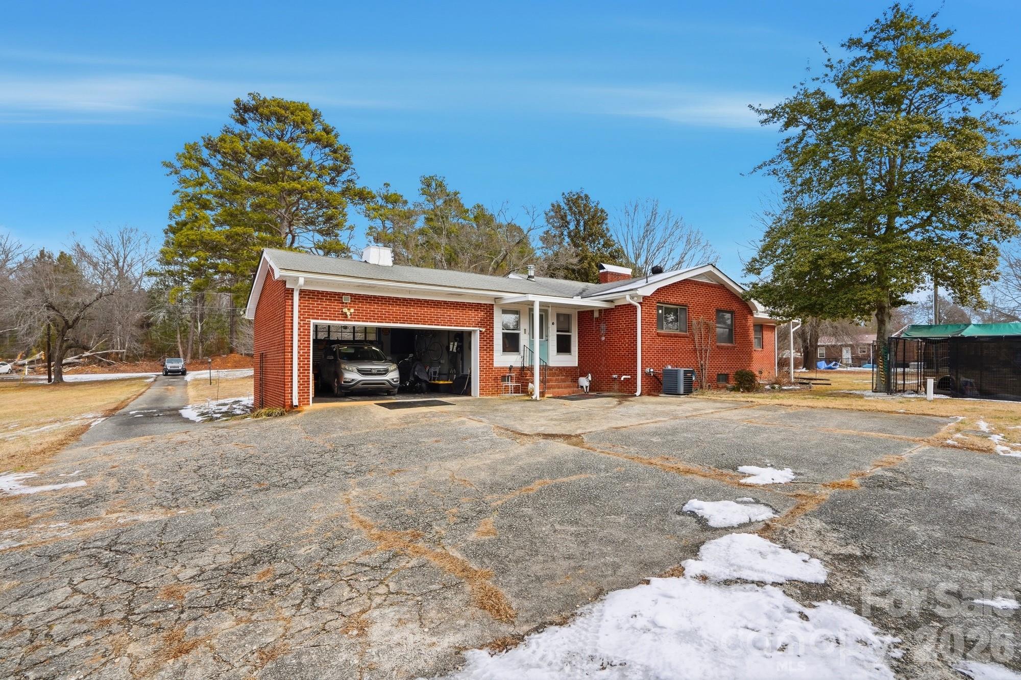 7511 Old Mocksville Road Salisbury, NC 28144 - Photo 29 of 48 a front view of a house with a yard and garage