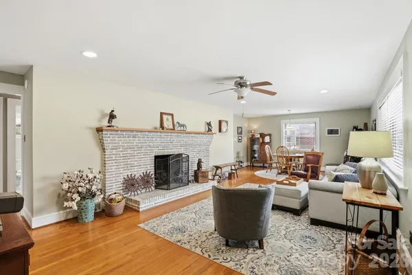 a living room with furniture a fireplace and a table