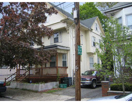 51 Baker Road Everett, MA 02149 - Photo 3 of 10 a view of a white building among the street with palm trees