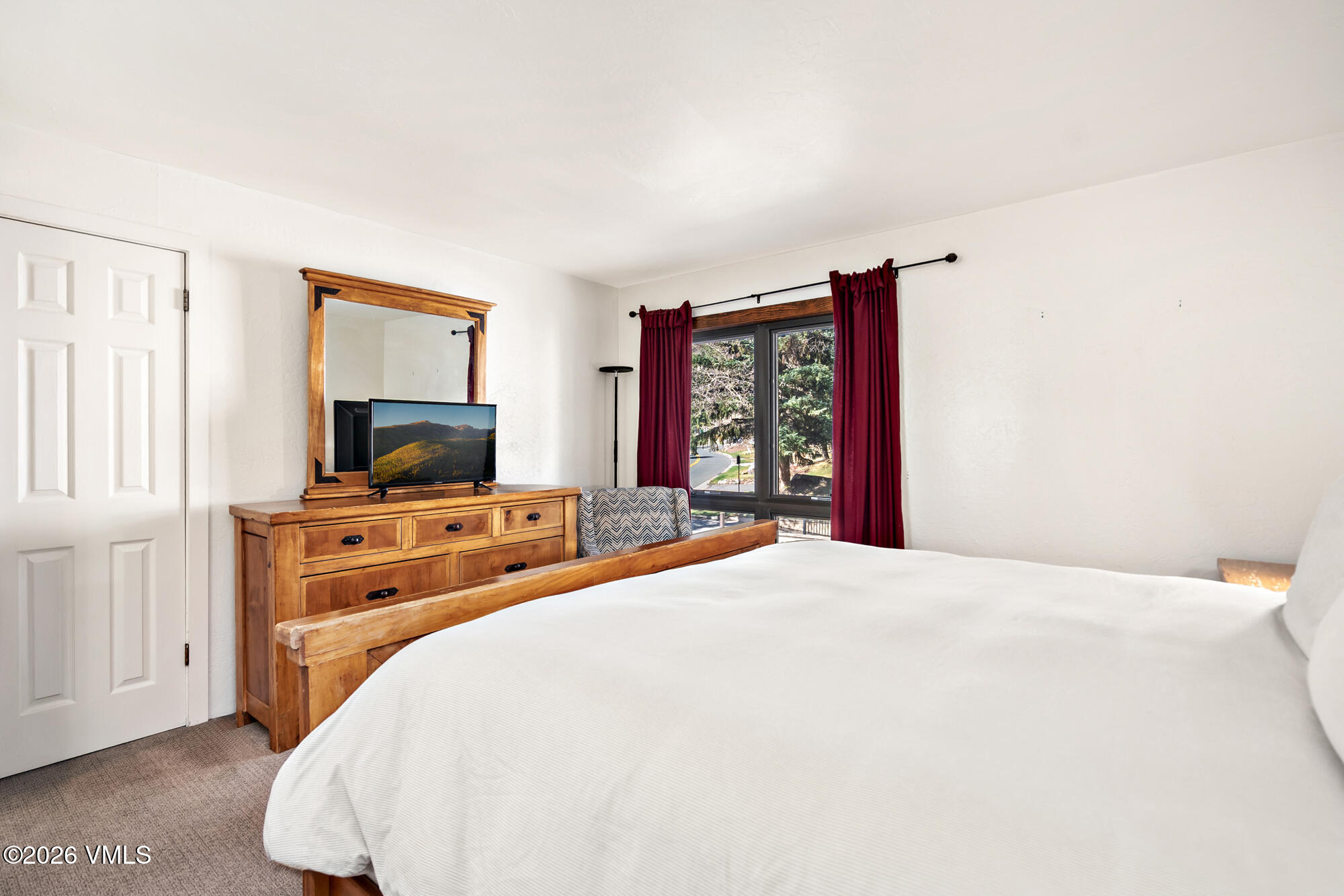 963 Lions Ridge Loop, Unit 502 Vail, CO 81657 - Photo 16 of 30 a bedroom with a bed and a flat screen tv