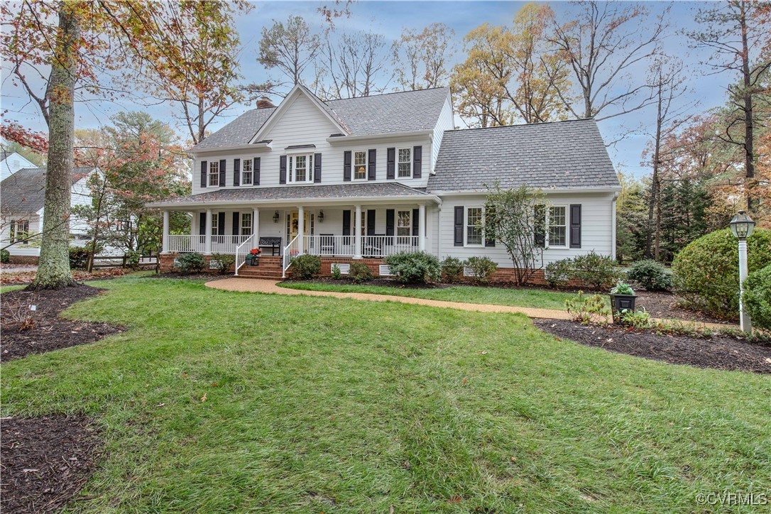 14161 Grangewood Road Midlothian, VA 23113 - Photo 2 of 44 a front view of a house with a yard table and chairs