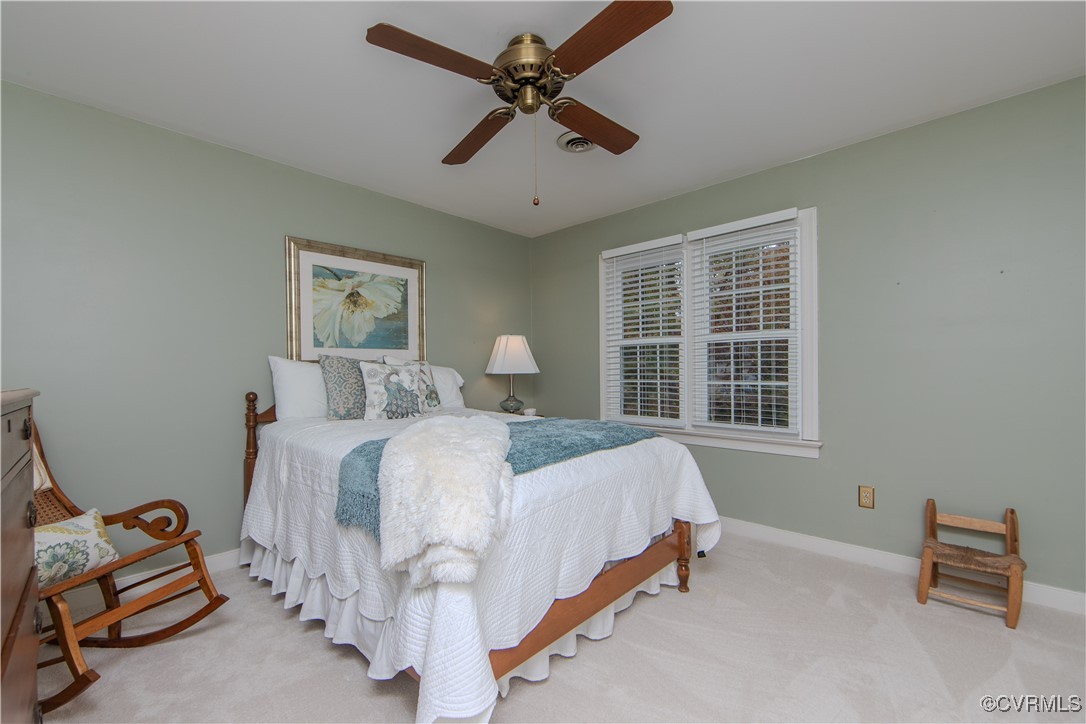 14161 Grangewood Road Midlothian, VA 23113 - Photo 28 of 44 a bedroom with a bed and a chandelier