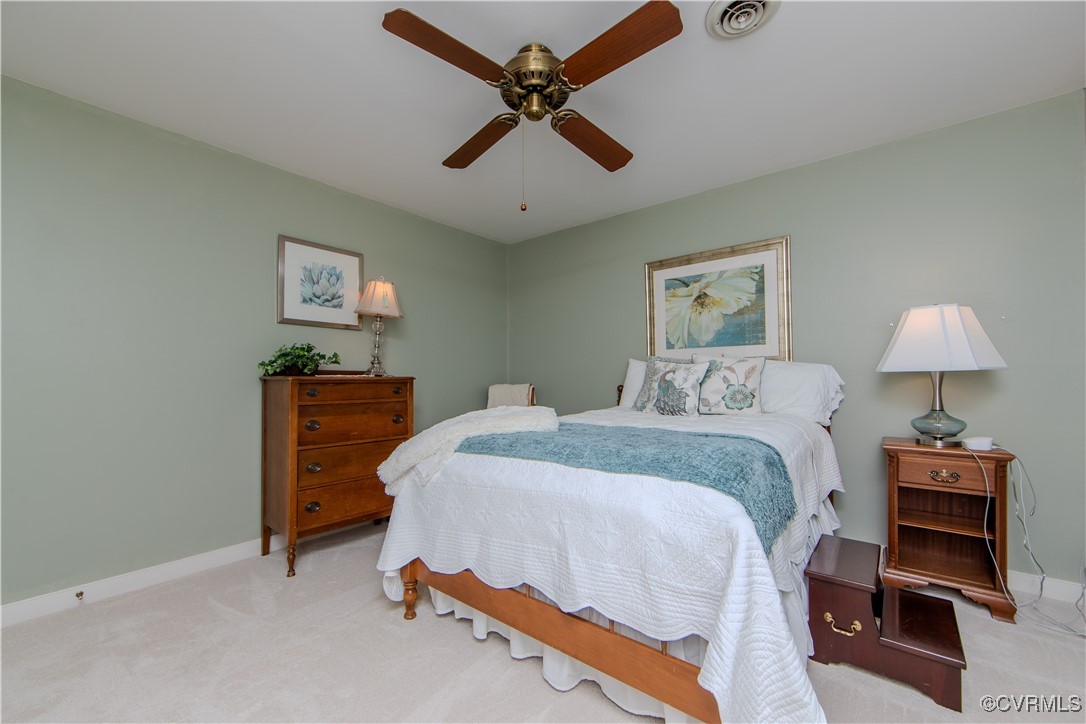14161 Grangewood Road Midlothian, VA 23113 - Photo 29 of 44 a bedroom with a bed and a lamp on the dresser