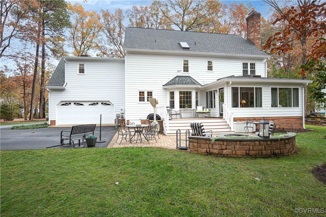 14161 Grangewood Road Midlothian, VA 23113 - Photo 38 of 44 a front view of a house with a garden and chairs