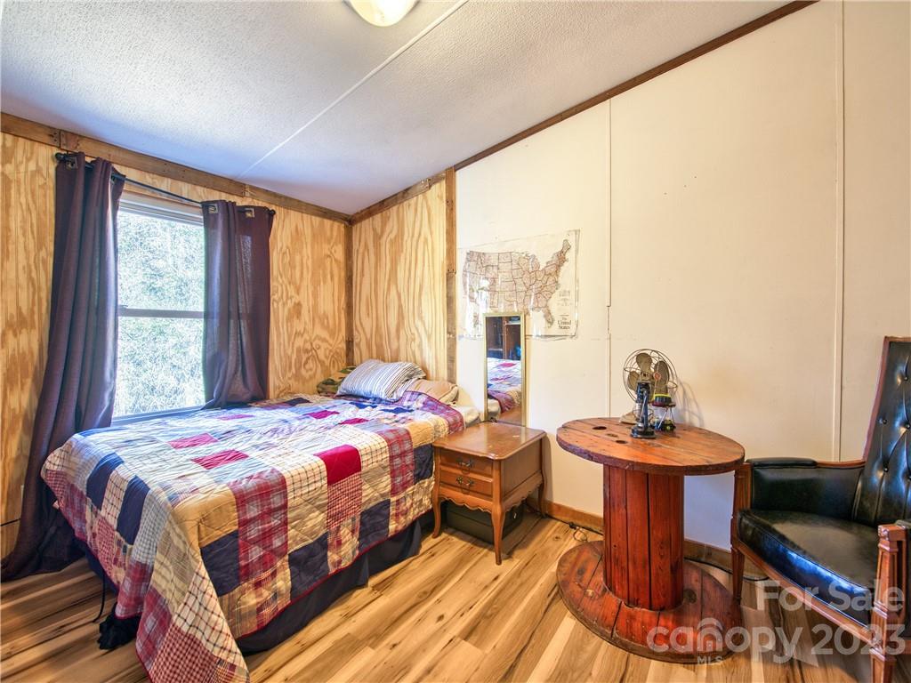 994 Indian Springs Road Clyde, NC 28721 - Photo 35 of 39 a bedroom with a bed and a table in it