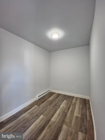 a view of room with wooden floor