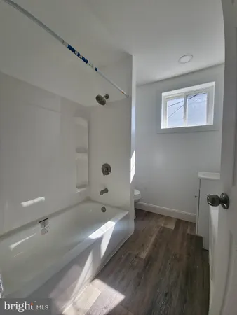 a bathroom with a tub and shower