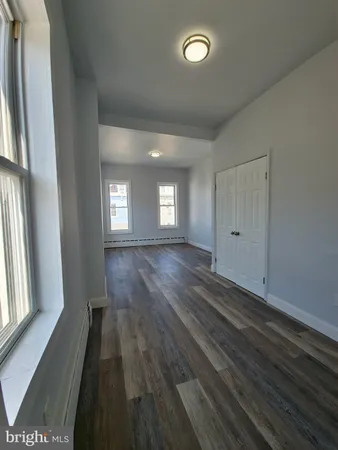 a view of wooden floor and windows in a room