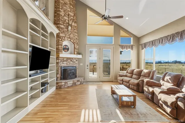 a living room with fireplace furniture and a flat screen tv