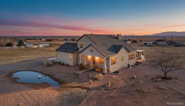 an aerial view of a house with a yard