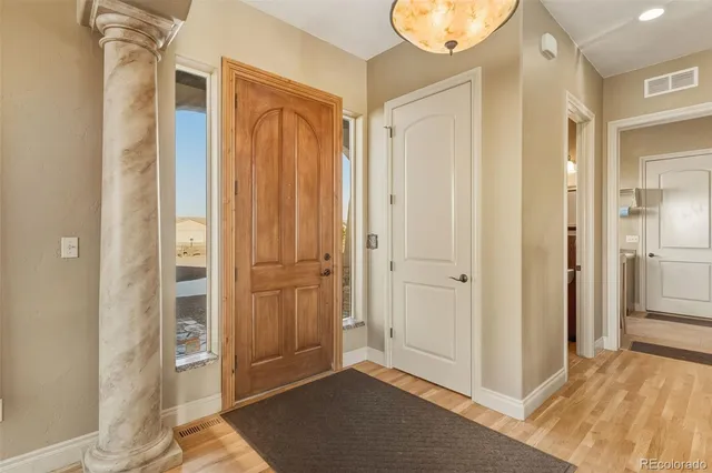 a view of a bathroom with wooden floor and mirror