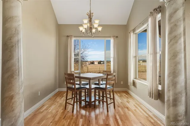 a view of a dining room with furniture window and wooden floor