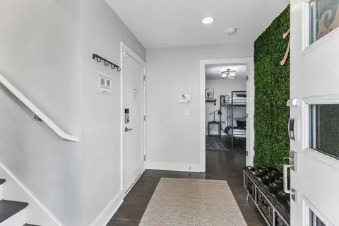 a view of a hallway with a livingroom and furniture