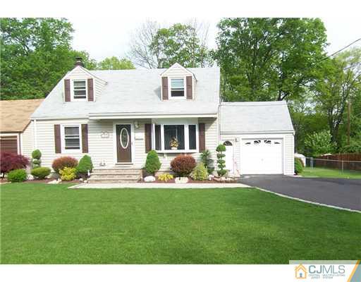 86 West Hill Road Colonia, NJ 07067 - Photo 1 of 10 a front view of a house with a yard and garage