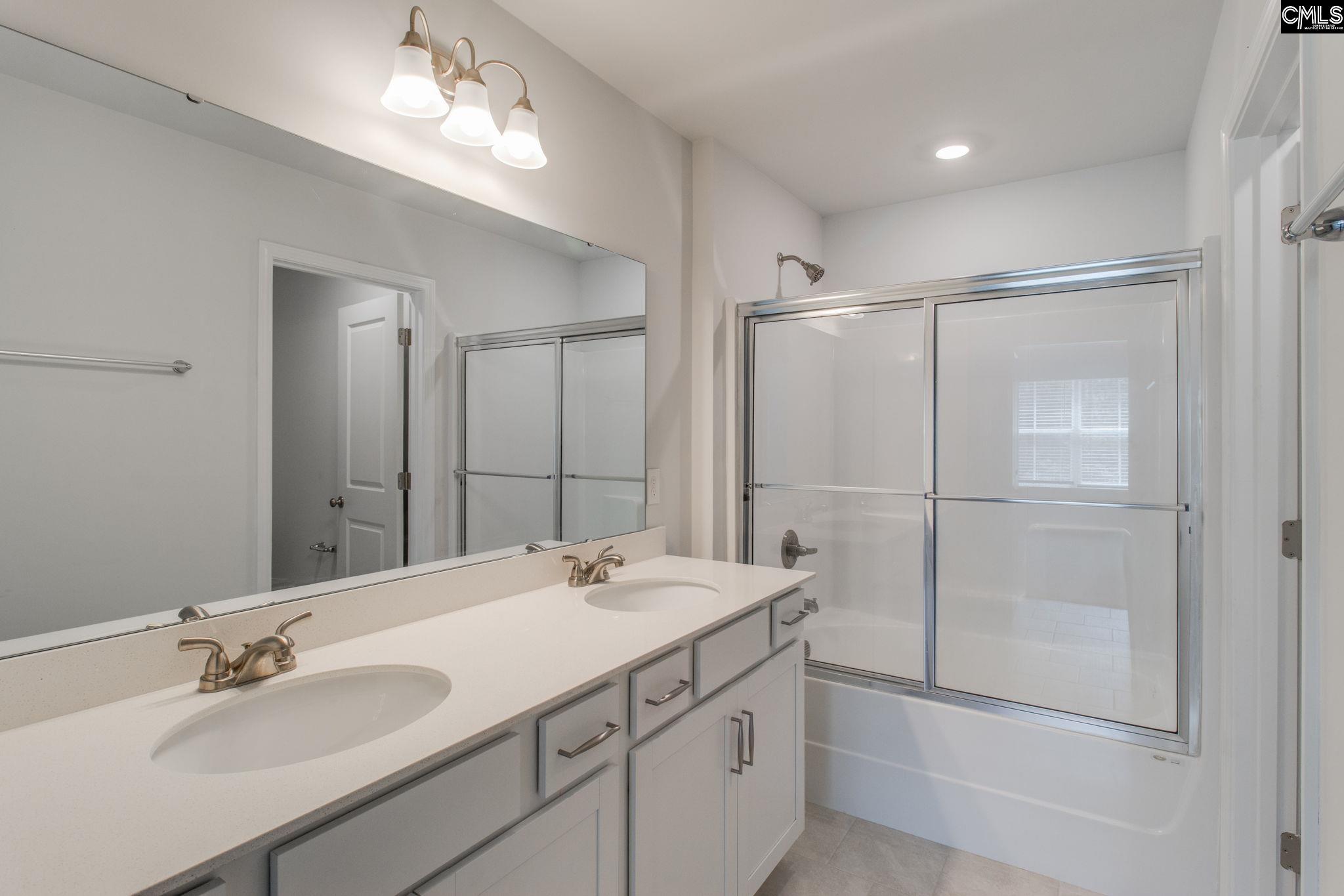 312 Reedmace Court Lexington, SC 29072 - Photo 18 of 29 a bathroom with a double vanity sink mirror and shower