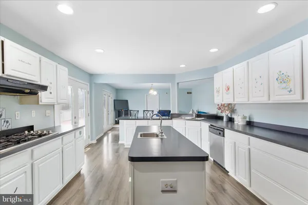 a kitchen with a sink a stove and cabinets