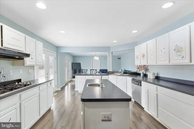 a kitchen with a sink a stove and cabinets