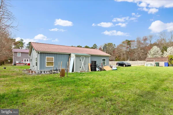 a view of a house with a yard porch and sitting area