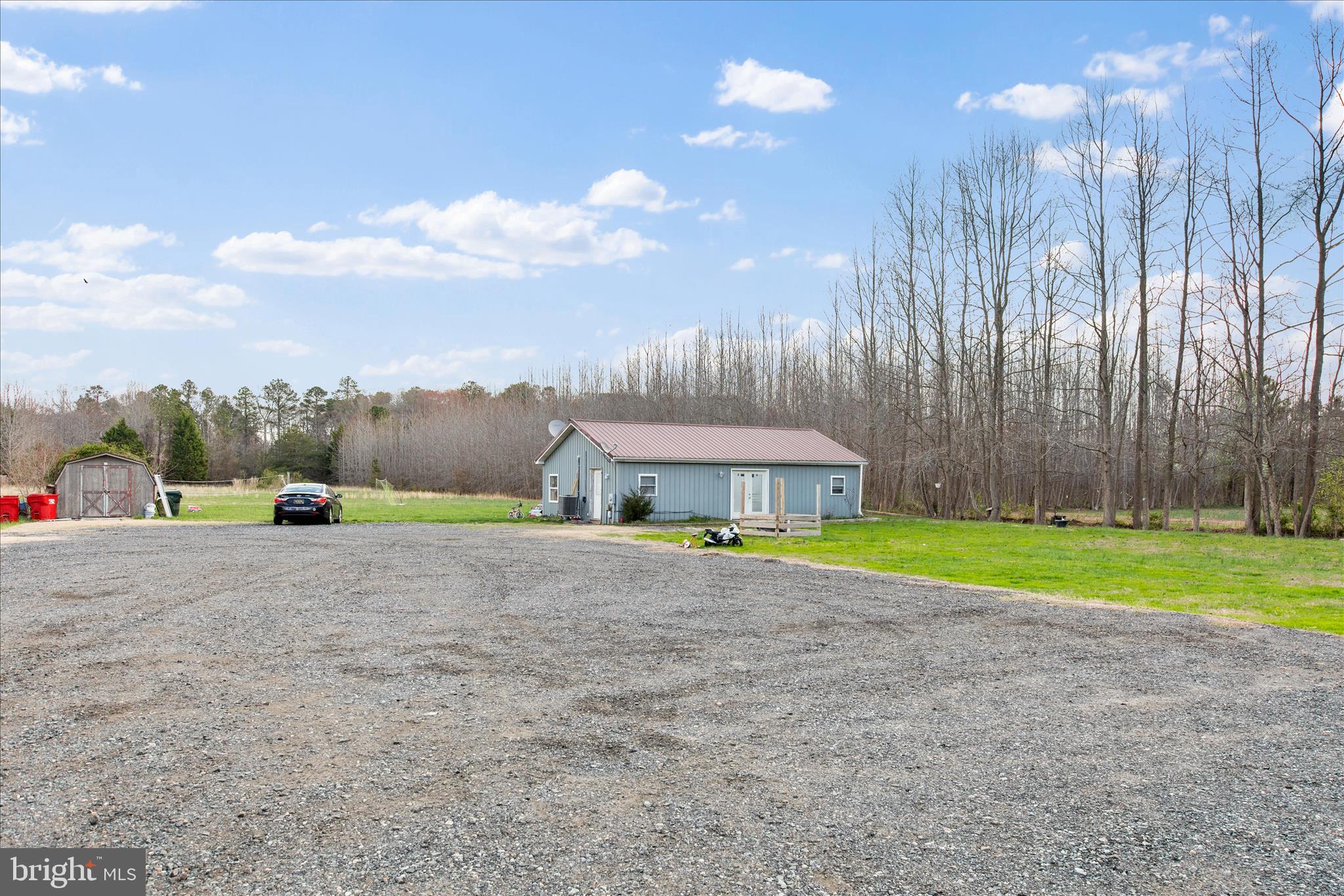 14477 Deer Forest Road Bridgeville, DE 19933 - Photo 17 of 22 a view of a house with a yard and a large parking space