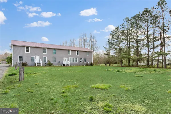 a view of a house with a yard and a garden