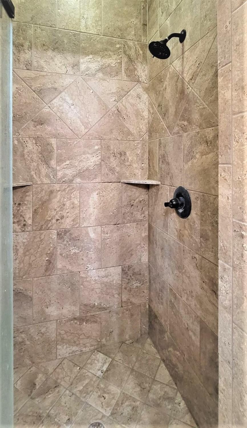 5234 Kemper Street Lubbock, TX 79416 - Photo 15 of 28 a bathroom with a shower