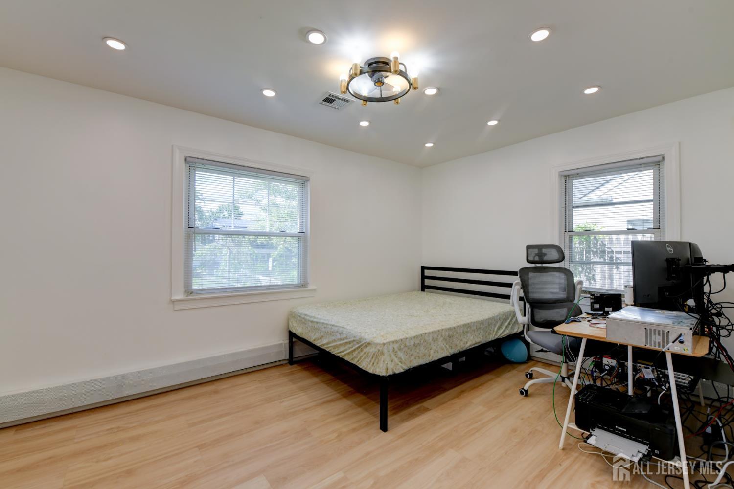 50 Chestnut Street Edison, NJ 08817 - Photo 15 of 36 a bedroom with a bed and a desk