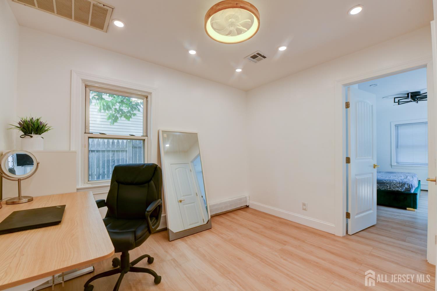 50 Chestnut Street Edison, NJ 08817 - Photo 18 of 36 a view of workspace and wooden floor in a room