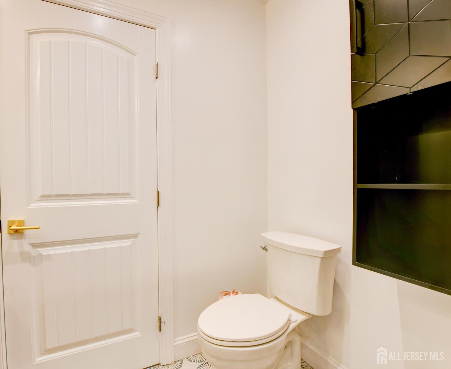 50 Chestnut Street Edison, NJ 08817 - Photo 23 of 36 a white toilet sitting next to a shower