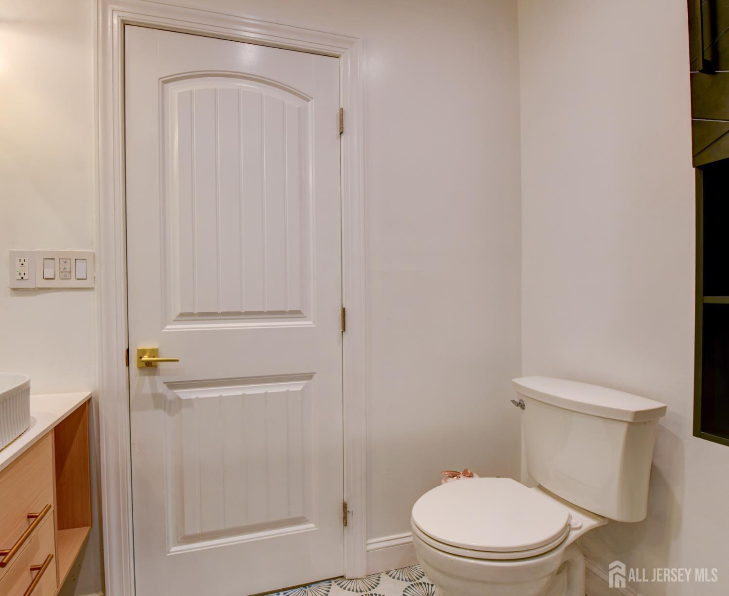 50 Chestnut Street Edison, NJ 08817 - Photo 24 of 36 a white toilet sitting next to a bathroom sink