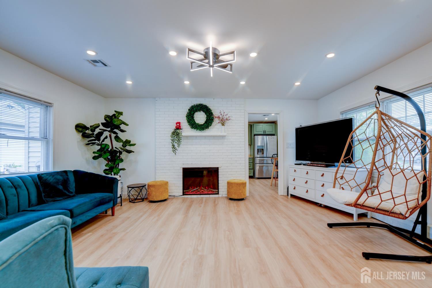 50 Chestnut Street Edison, NJ 08817 - Photo 25 of 36 a living room with furniture and a flat screen tv