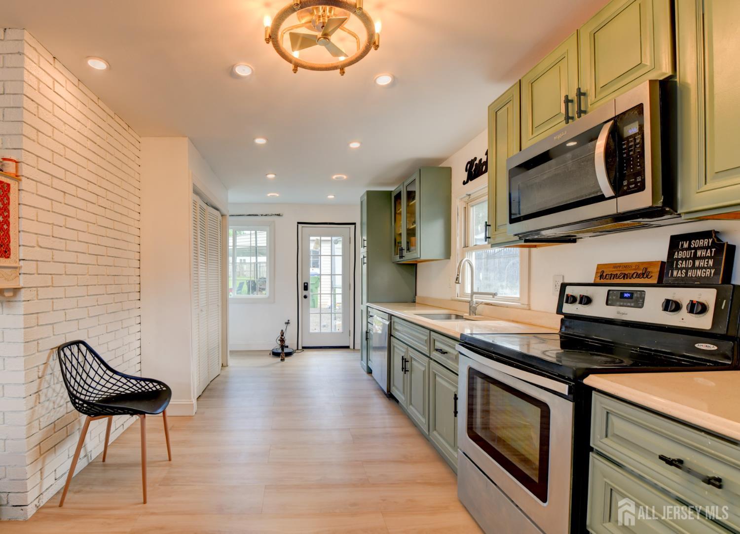 50 Chestnut Street Edison, NJ 08817 - Photo 8 of 36 a kitchen with stainless steel appliances a stove a sink and a microwave