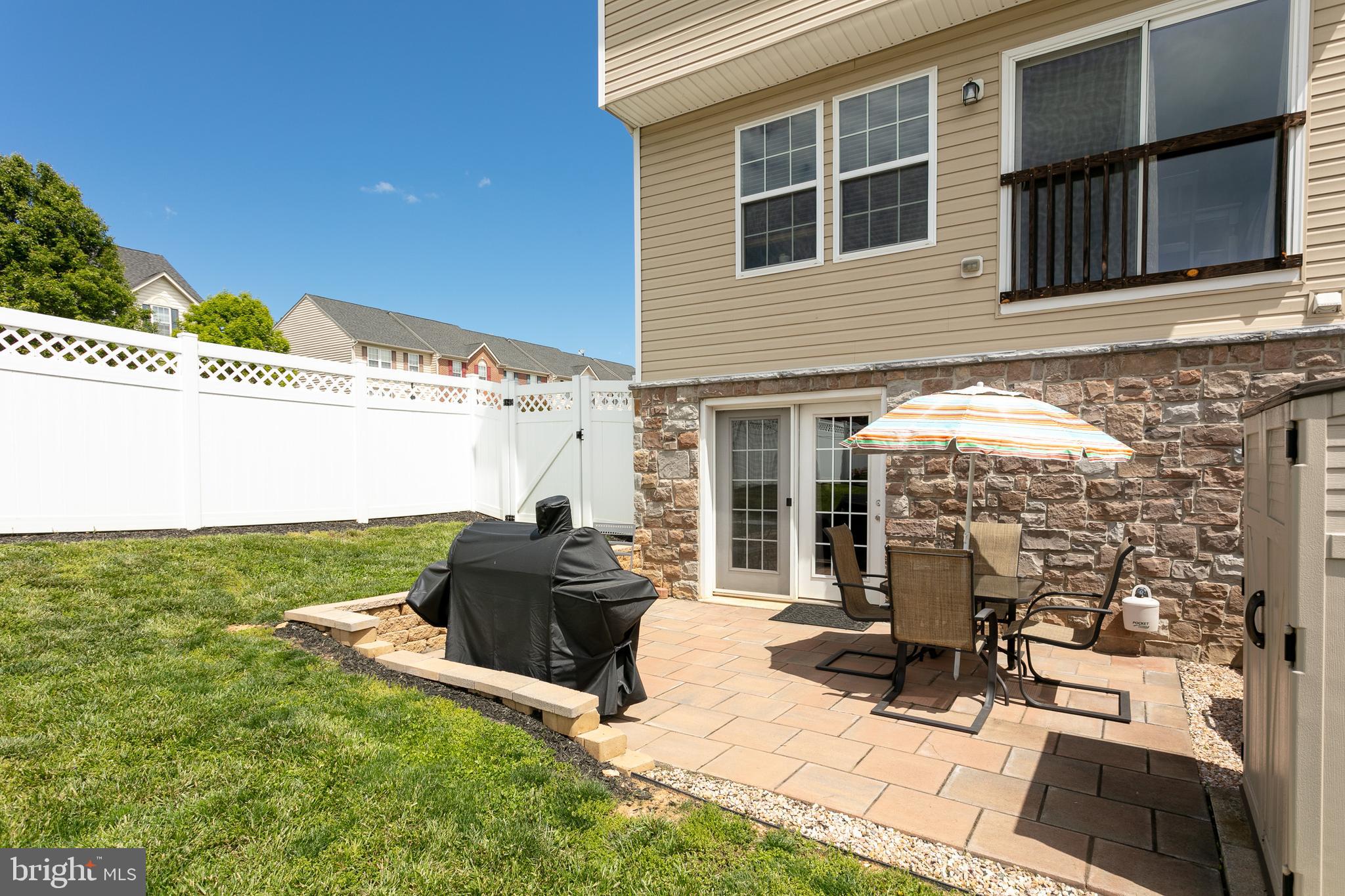 16 Baltic Lane Ranson, WV 25438 - Photo 5 of 24 Stone rear wall and patio