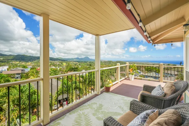 a view of a patio with couches chairs potted plants and city view